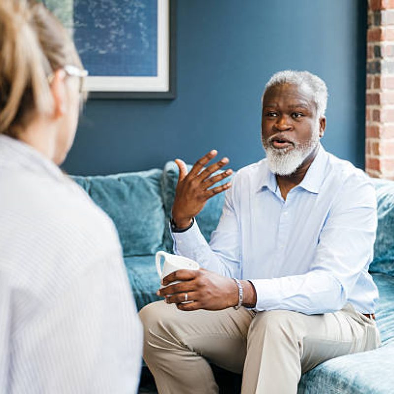 Senior person during therapy session with a health professional